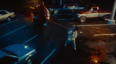 a man pulling a fire hose across a parking lot