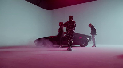 a man standing next to a car in a room