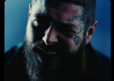 a bearded man with tattoos on his face