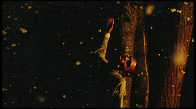 two people reaching for a frisbee in the dark