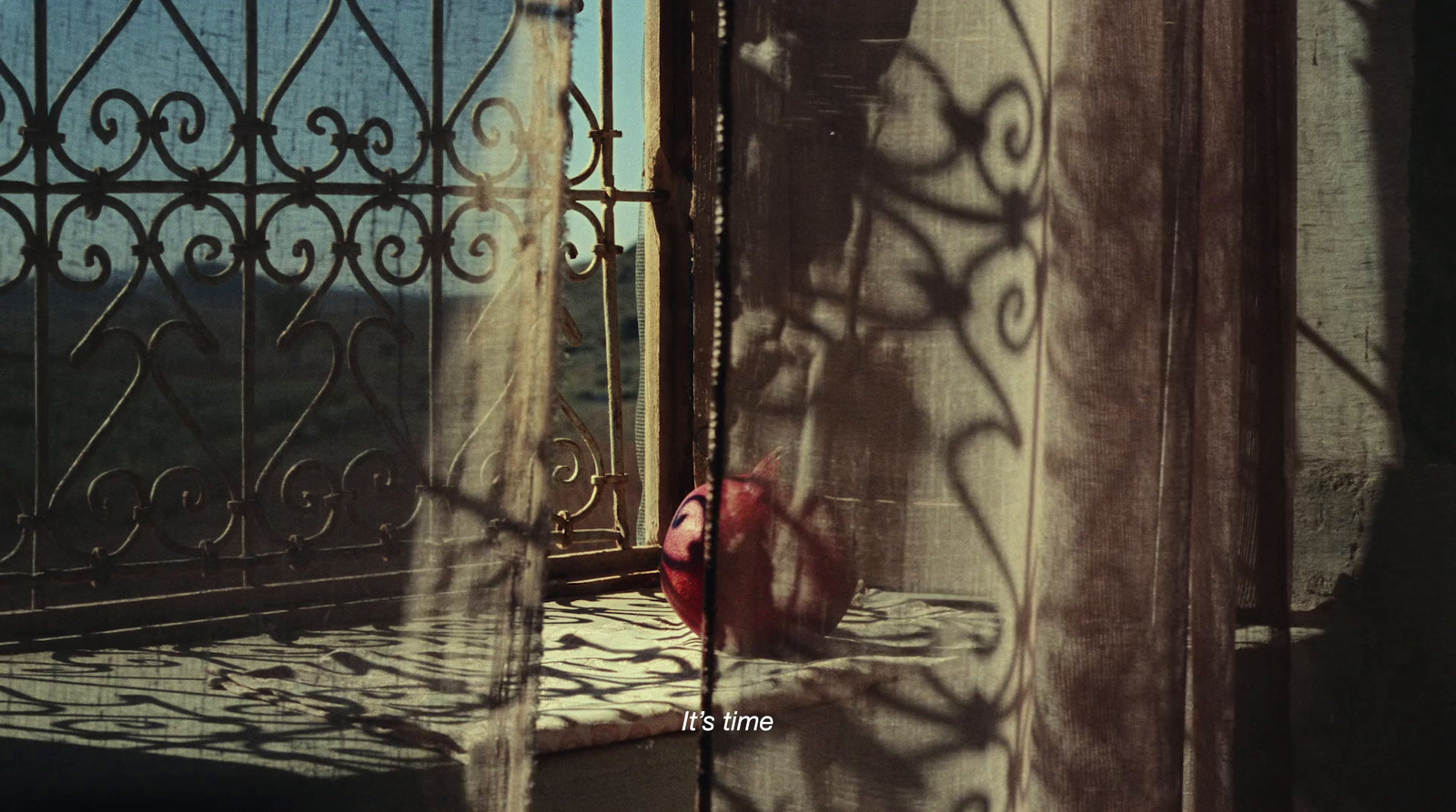 a red bag sitting on top of a window sill