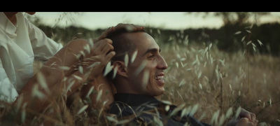 a man sitting in a field of tall grass