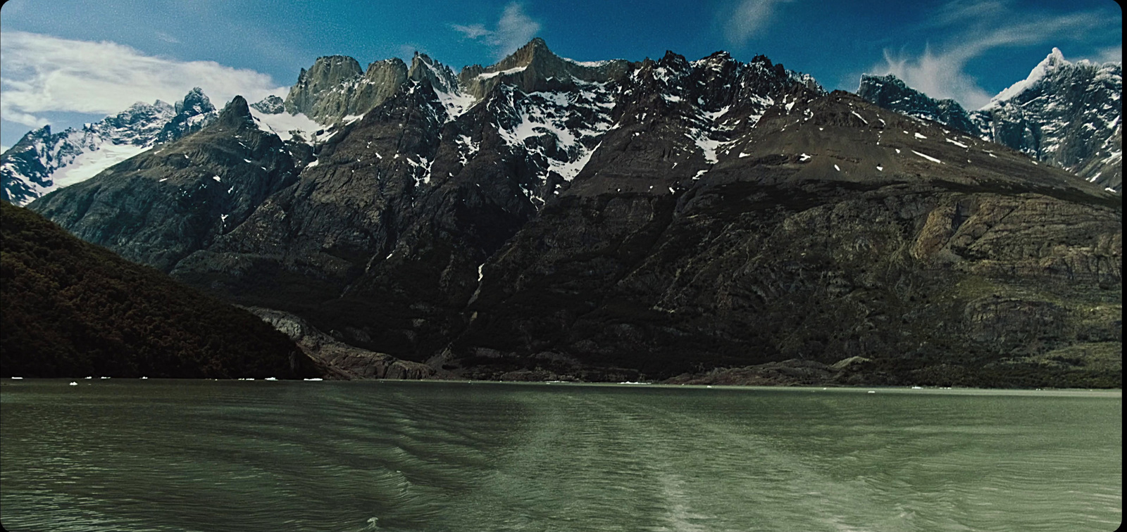 a mountain range with a body of water in front of it