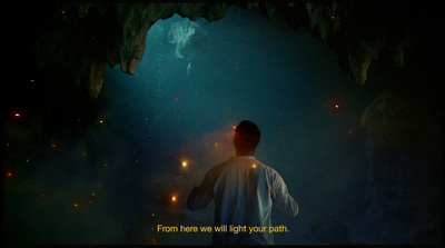 a man standing in front of a cave