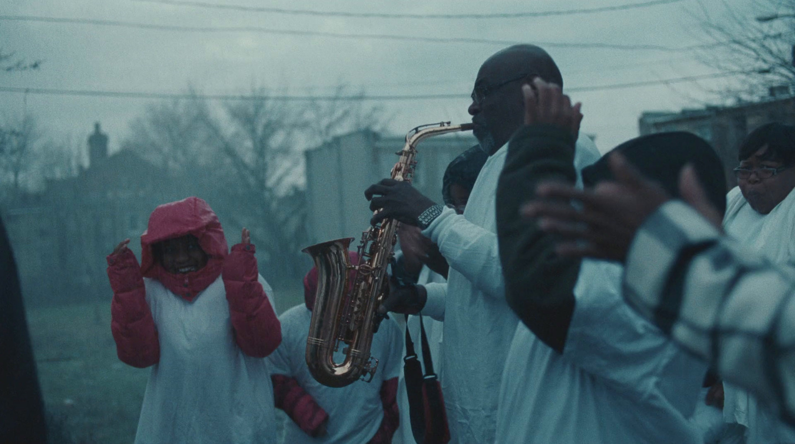 a group of people standing around each other holding musical instruments