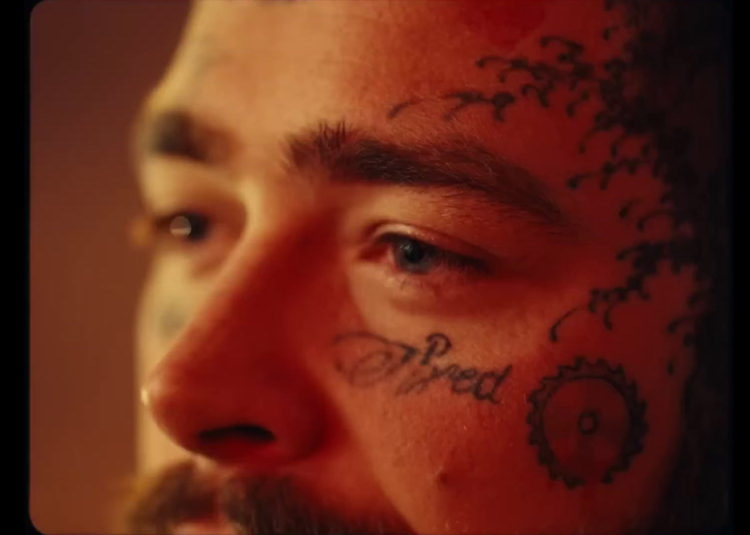 a close up of a man with tattoos on his face