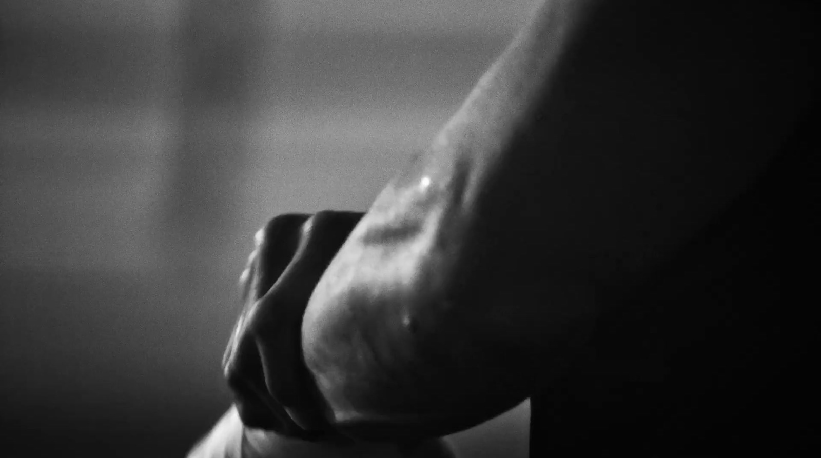 a black and white photo of a person holding a knife