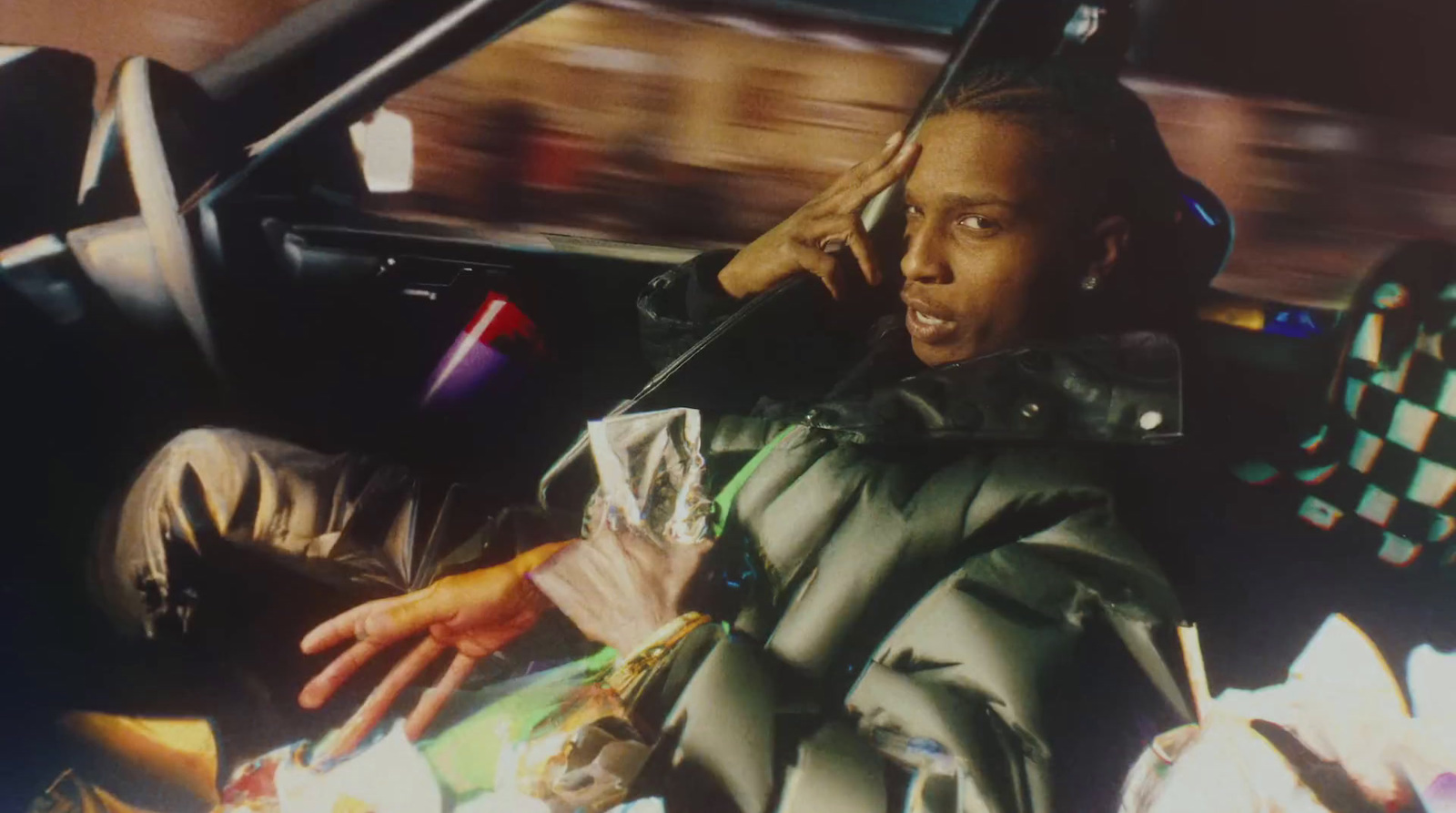 a man sitting in a car talking on a cell phone