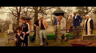 a group of people standing around a cemetery