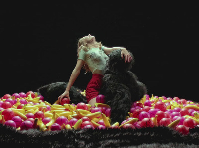 a woman standing on top of a pile of balloons