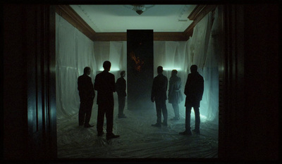 a group of people standing in a dark room