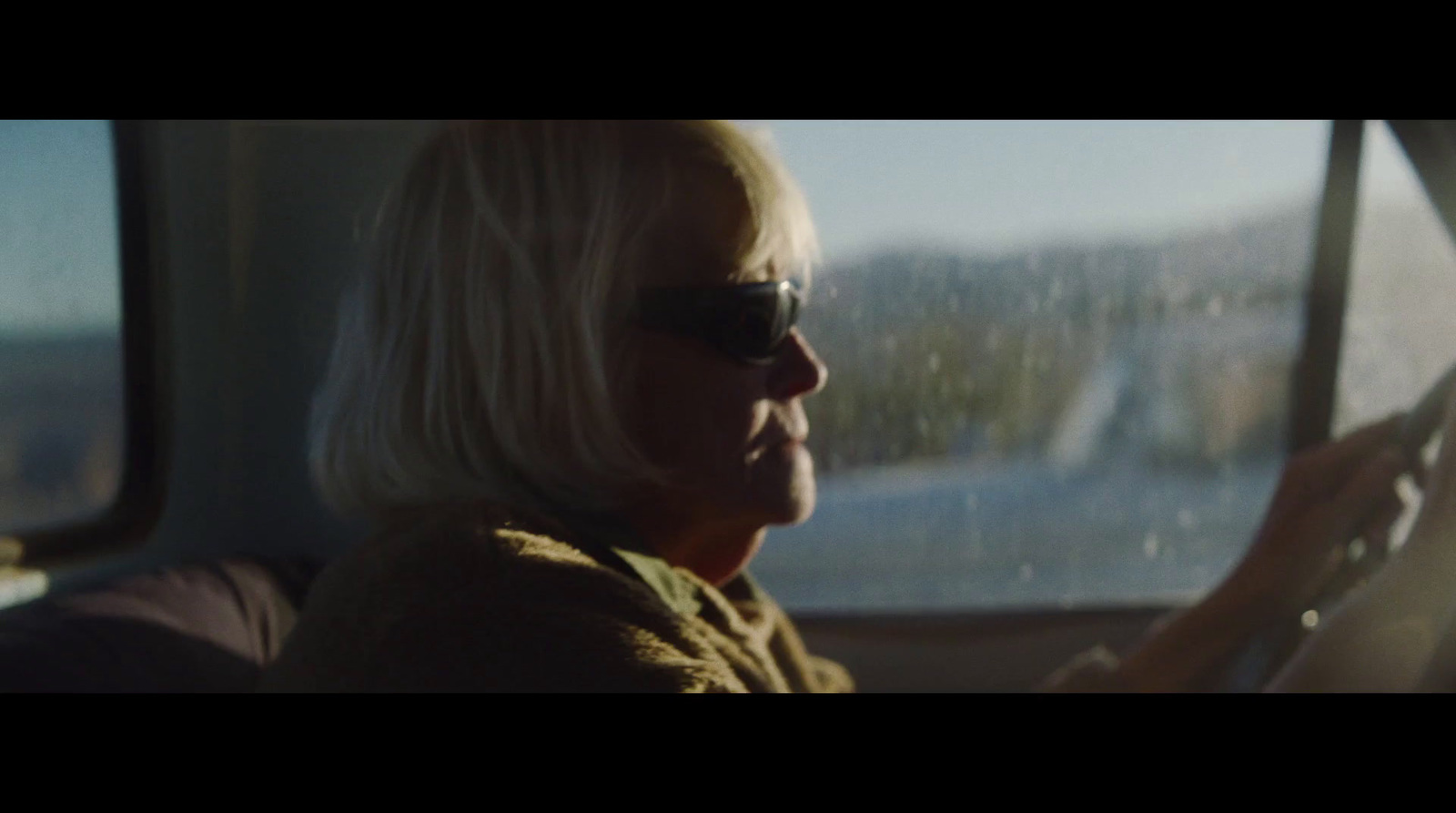 a woman driving a car in the rain