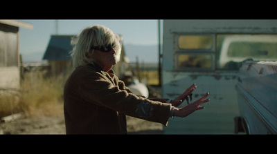 a woman standing next to a white bus