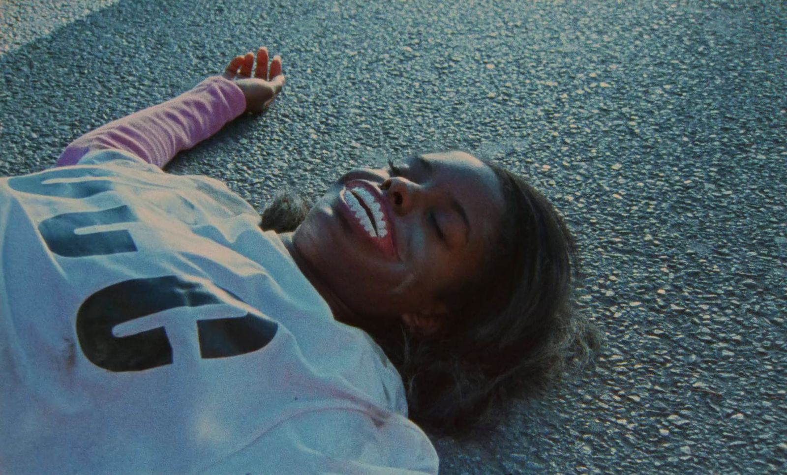 a woman laying on the ground with her eyes closed