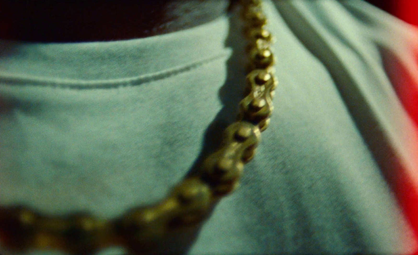 a close up of a person wearing a necklace