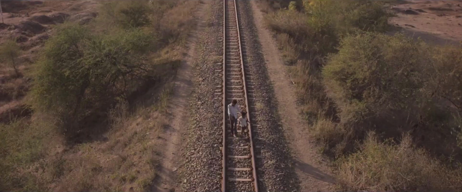 a train traveling down train tracks through a rural countryside