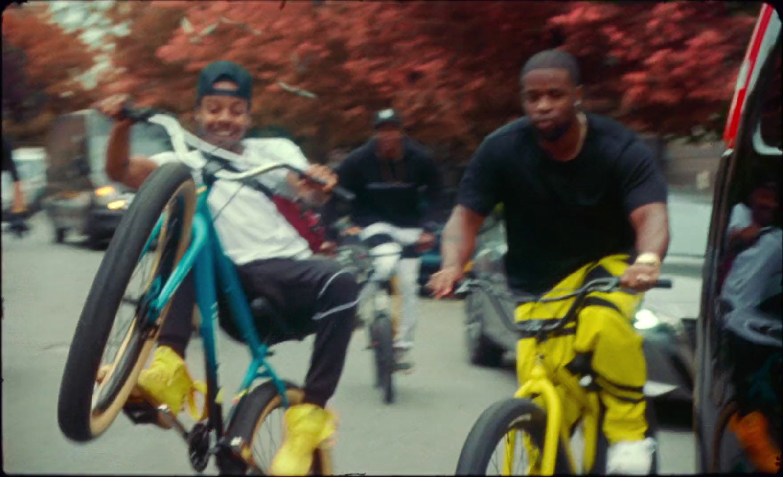 a couple of men riding bikes down a street