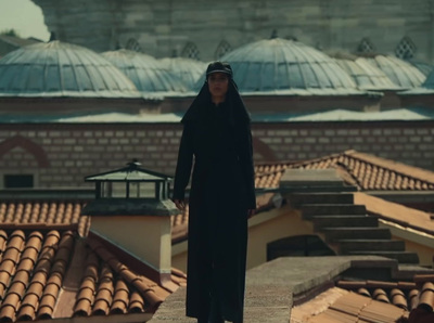 a woman standing on top of a roof