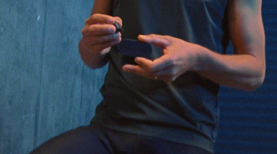 a person holding a cell phone in their hands