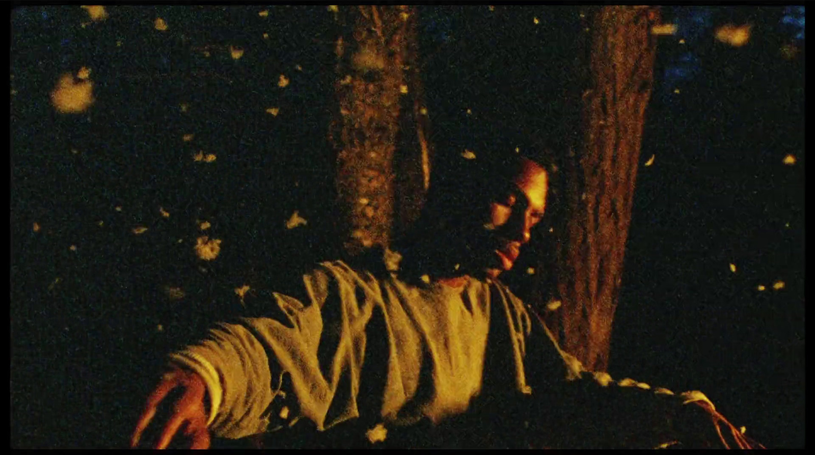 a man is sitting in the dark with a frisbee