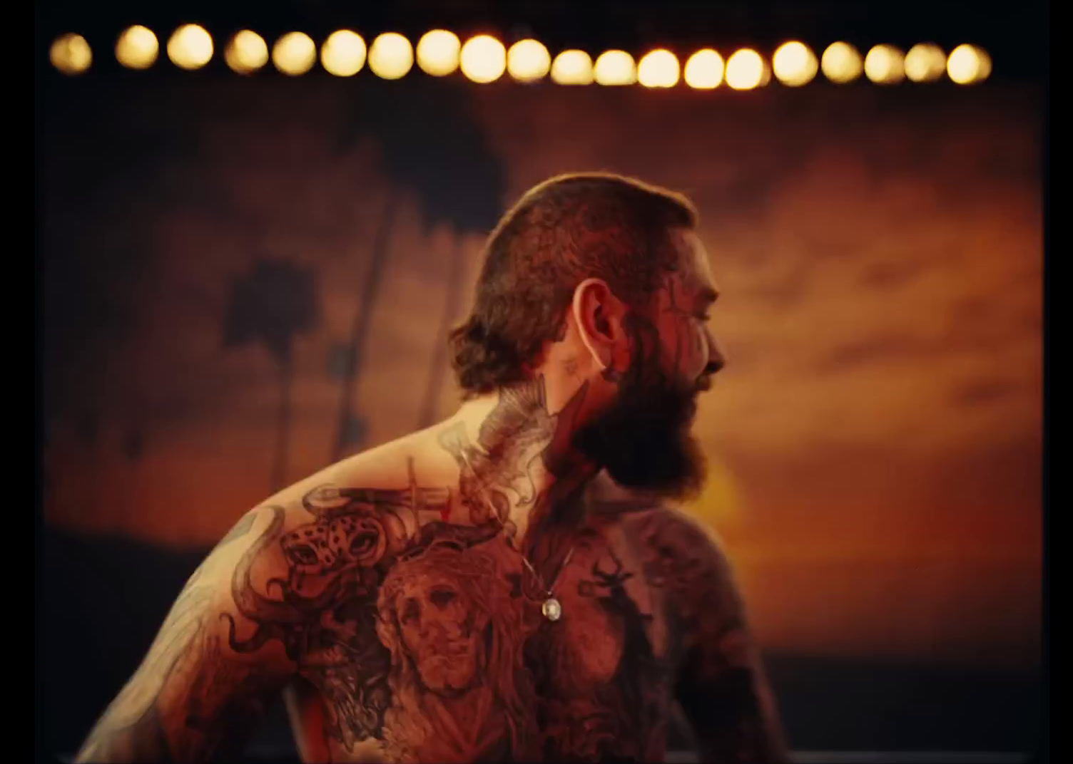 a man with a full beard and tattoos