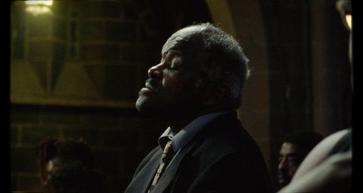 a man in a suit and tie looking off into the distance