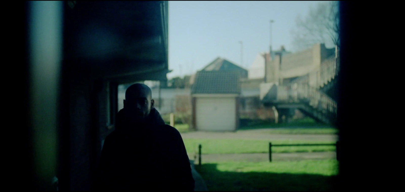 a man standing in front of a window in a house