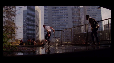 a couple of men riding skateboards down a street