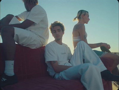 a group of people sitting on top of a red couch