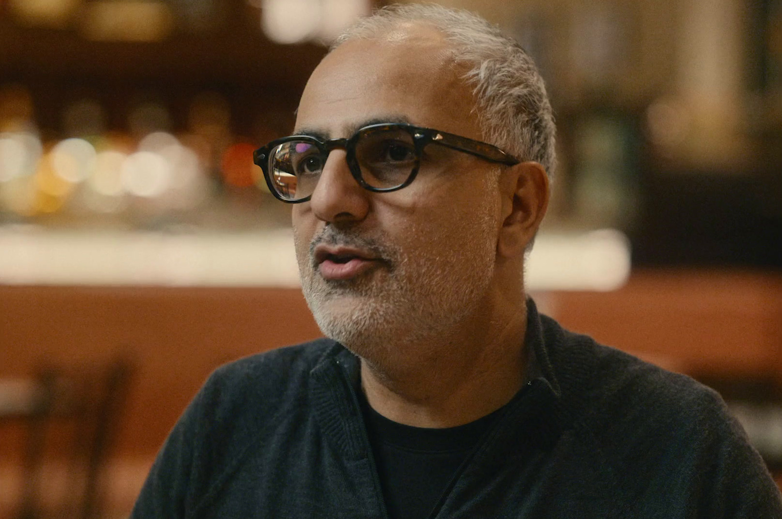 a man wearing glasses and a black shirt