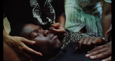 a man getting his hair cut by a woman