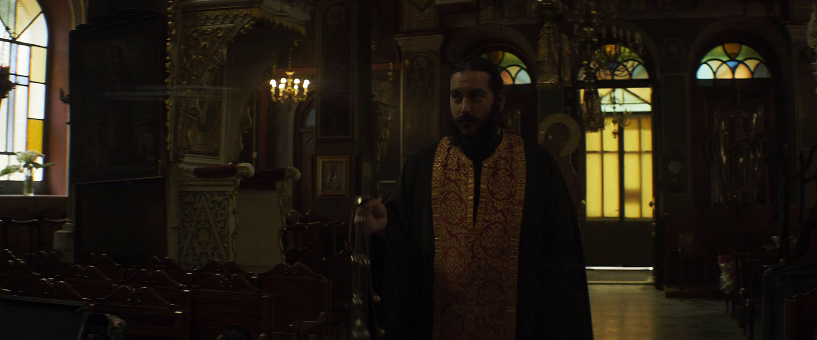 a man in a priest's robes standing in a church