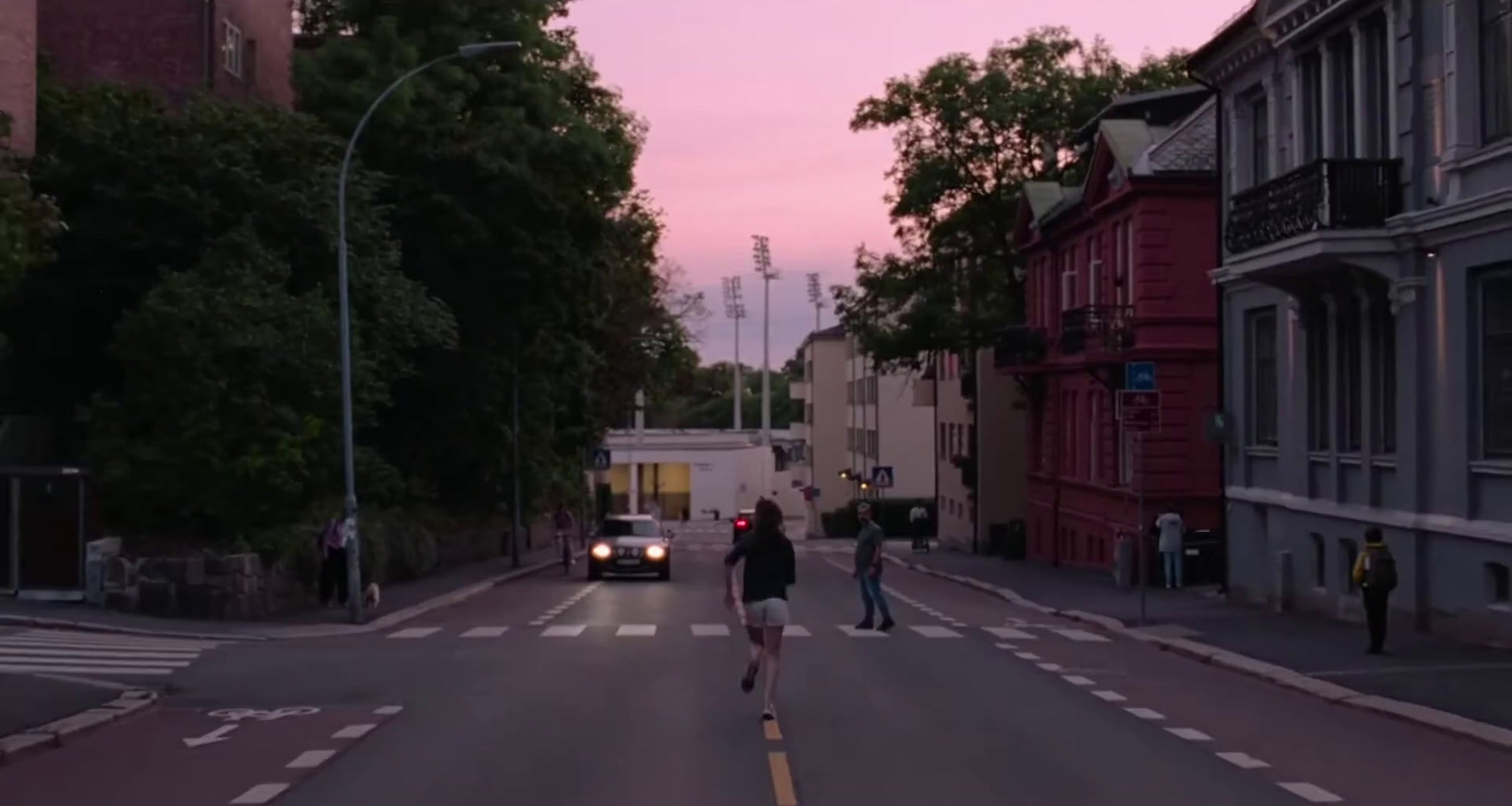 a couple of people walking down a street