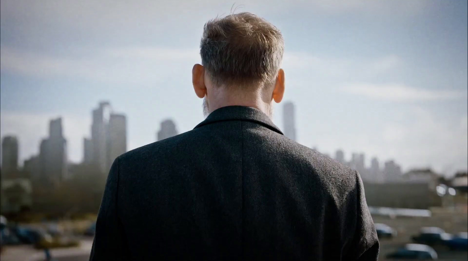 a man standing in front of a city skyline