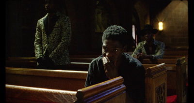 a woman sitting in a church with other people