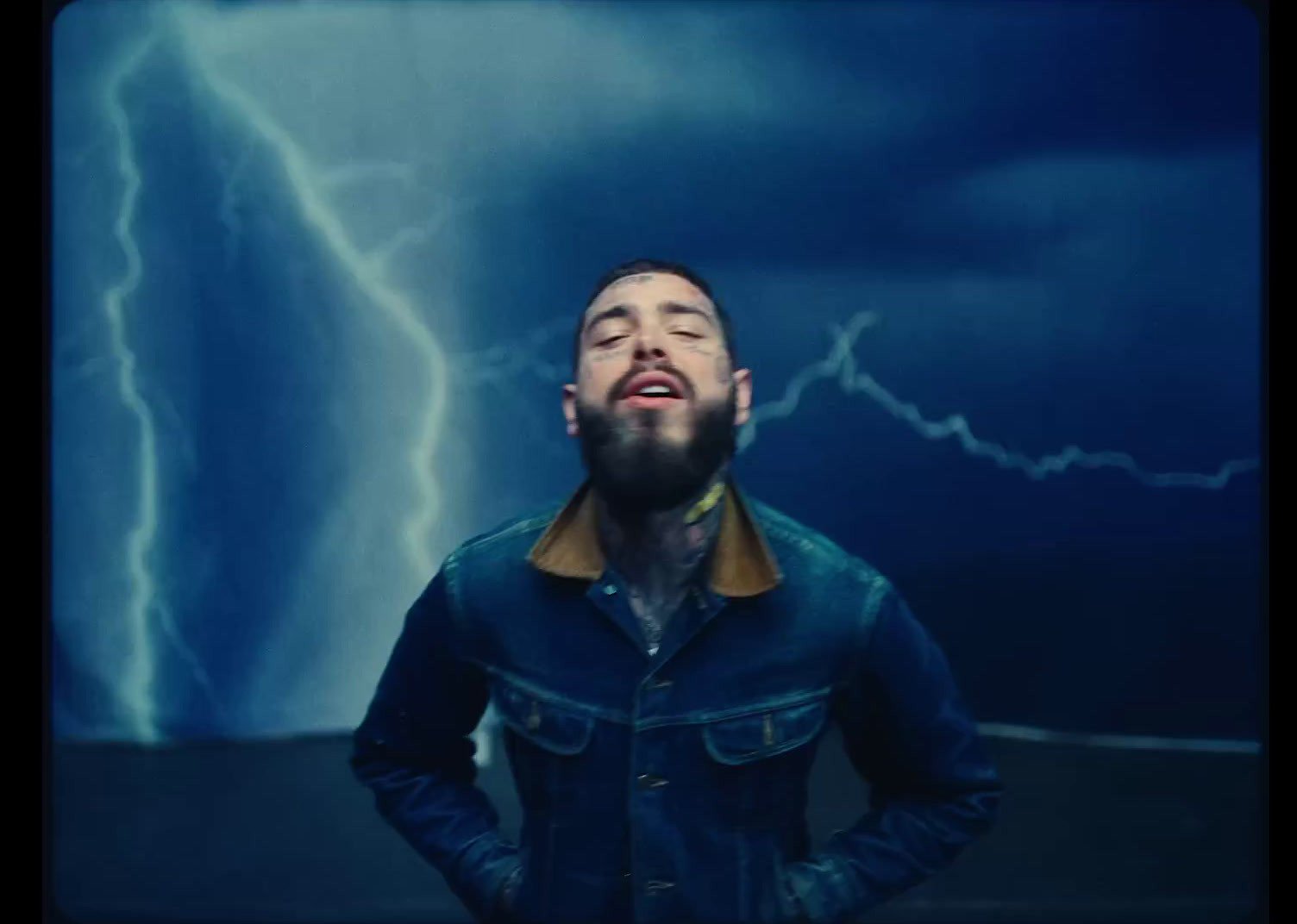 a man standing in front of a lightning storm