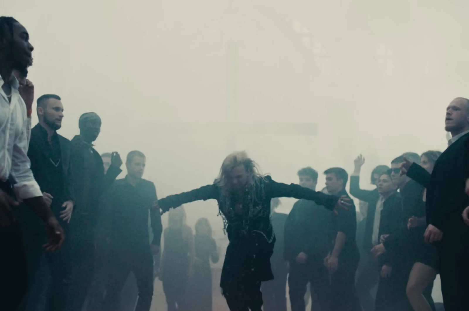 a group of people standing in a foggy area