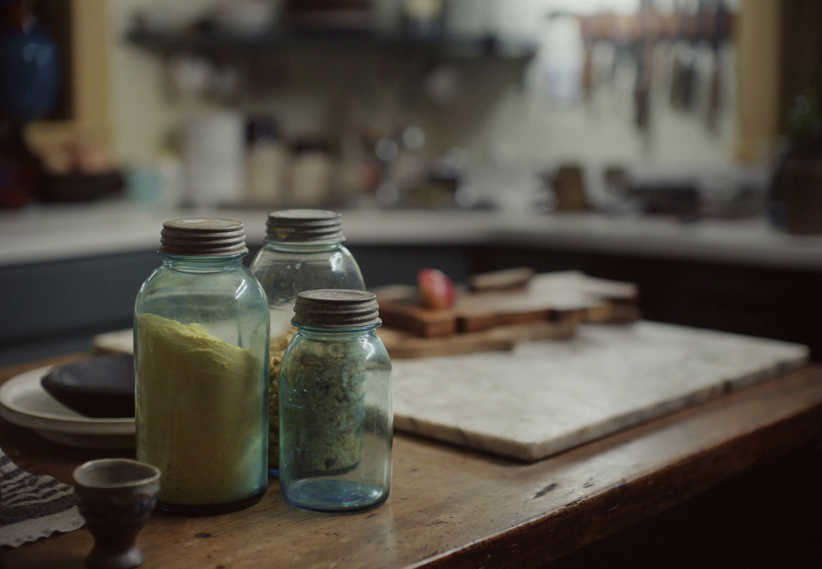 a couple of jars sitting on top of a wooden table