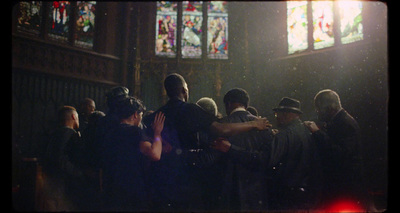 a group of people standing in front of a stained glass window