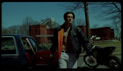 a man standing next to a red truck