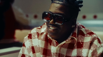 a man wearing sunglasses and a checkered shirt