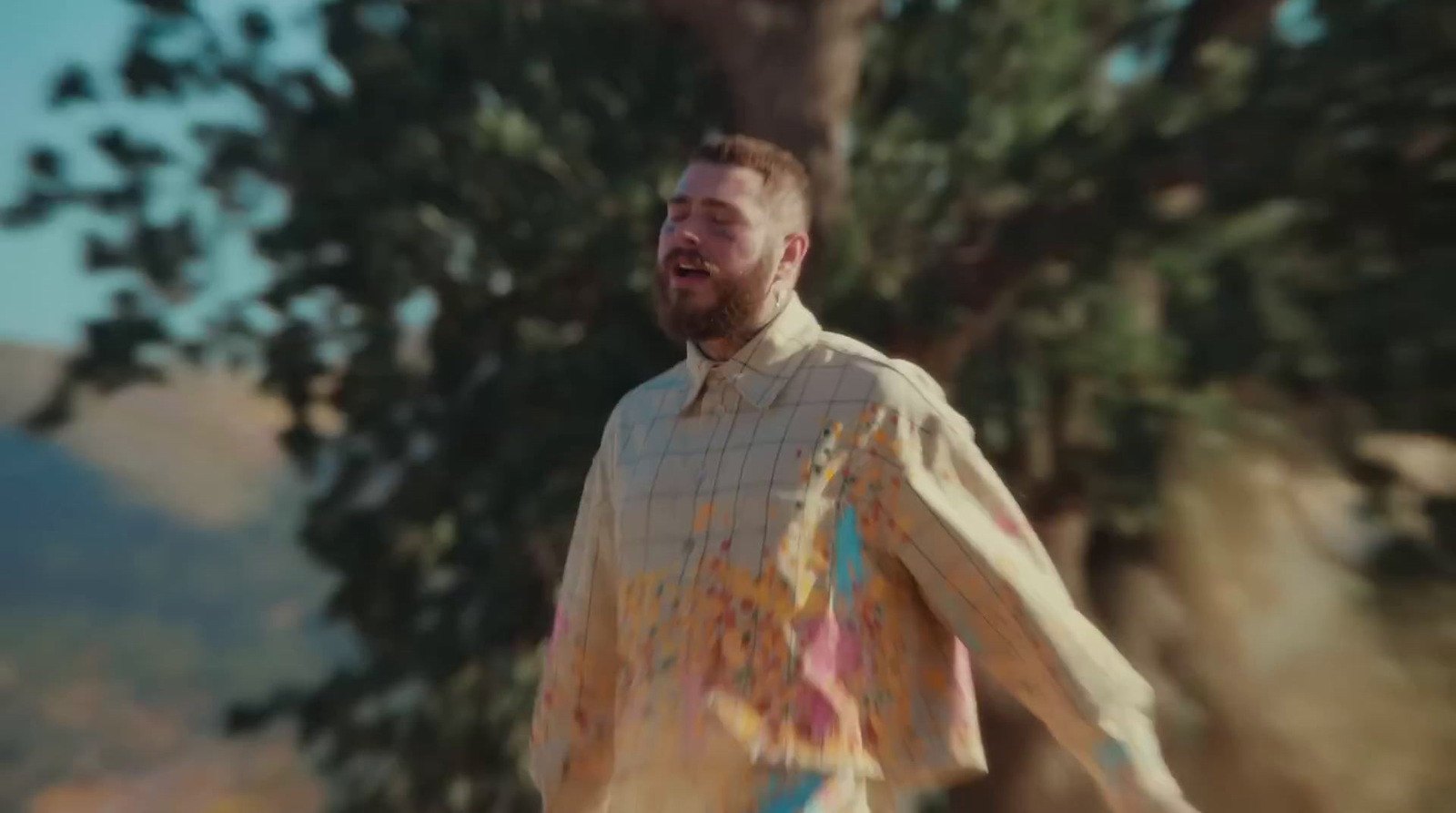 a man with a beard and a colorful shirt