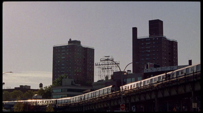 a train traveling through a city next to tall buildings