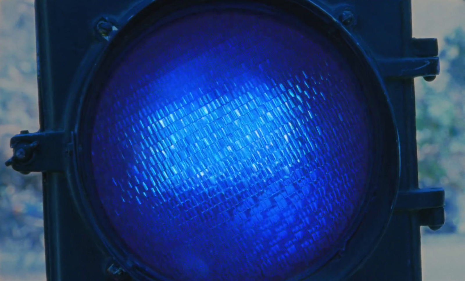 a close up of a blue traffic light