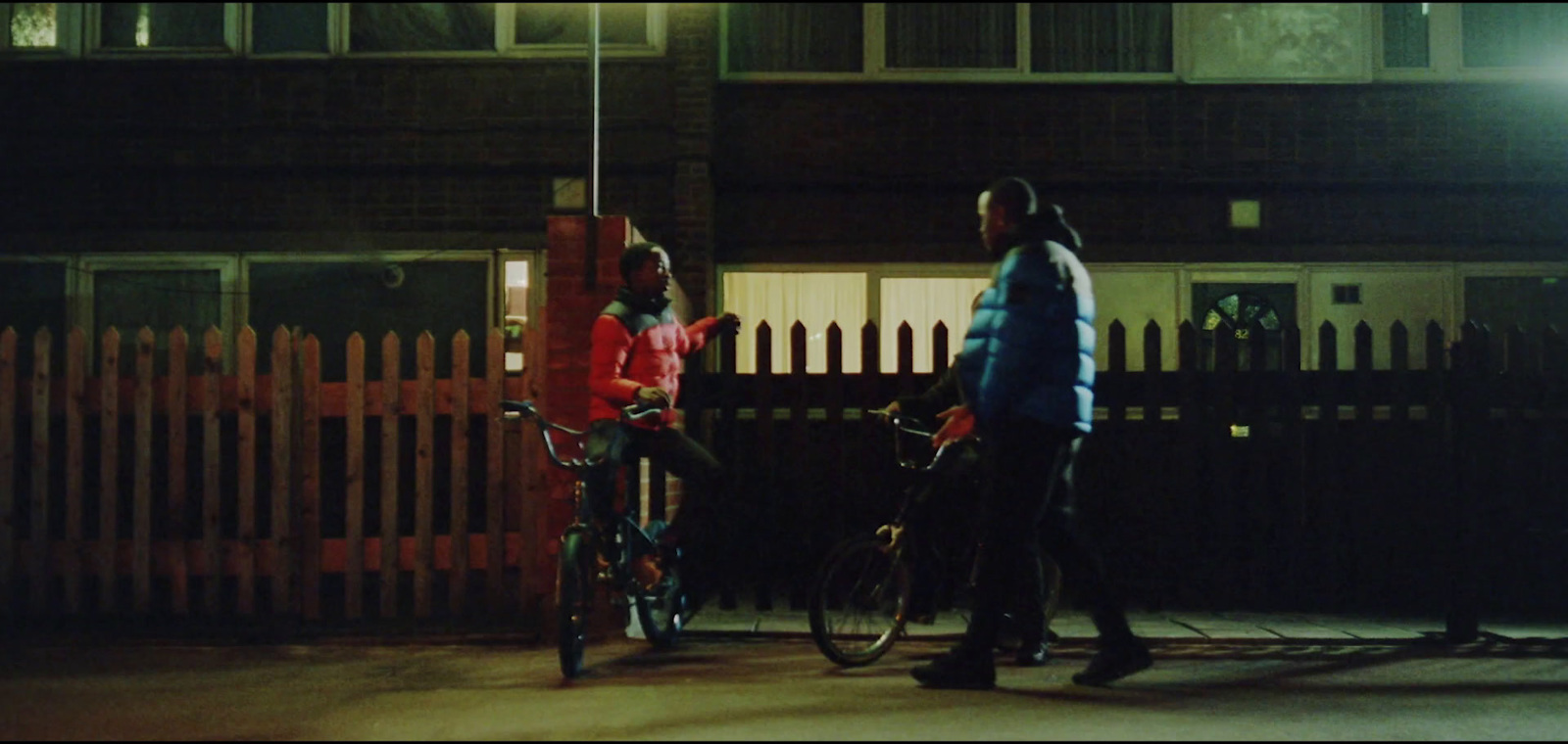 a couple of people that are standing next to a bike