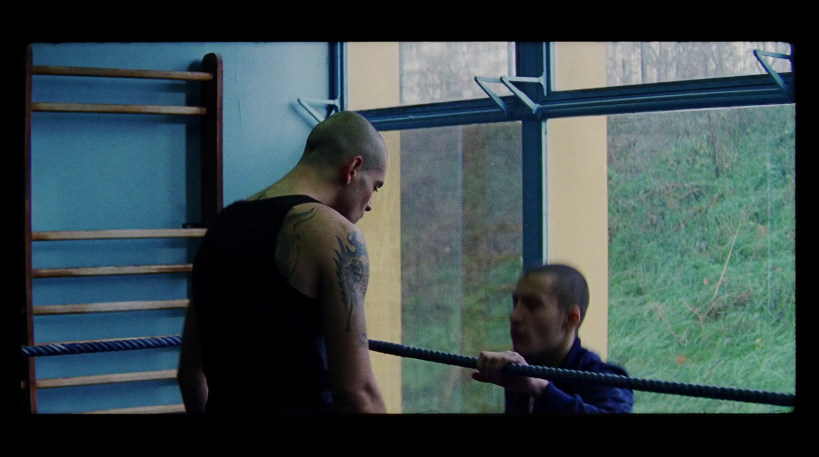 a man holding a rope while another man watches