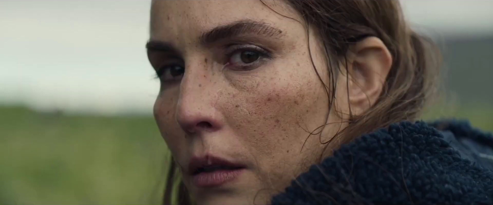 a close up of a woman with freckles on her face