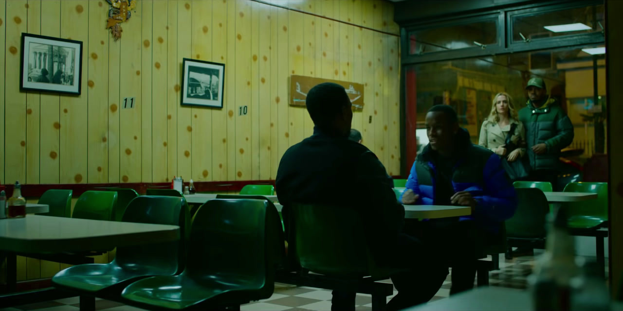 a group of people sitting at tables in a restaurant