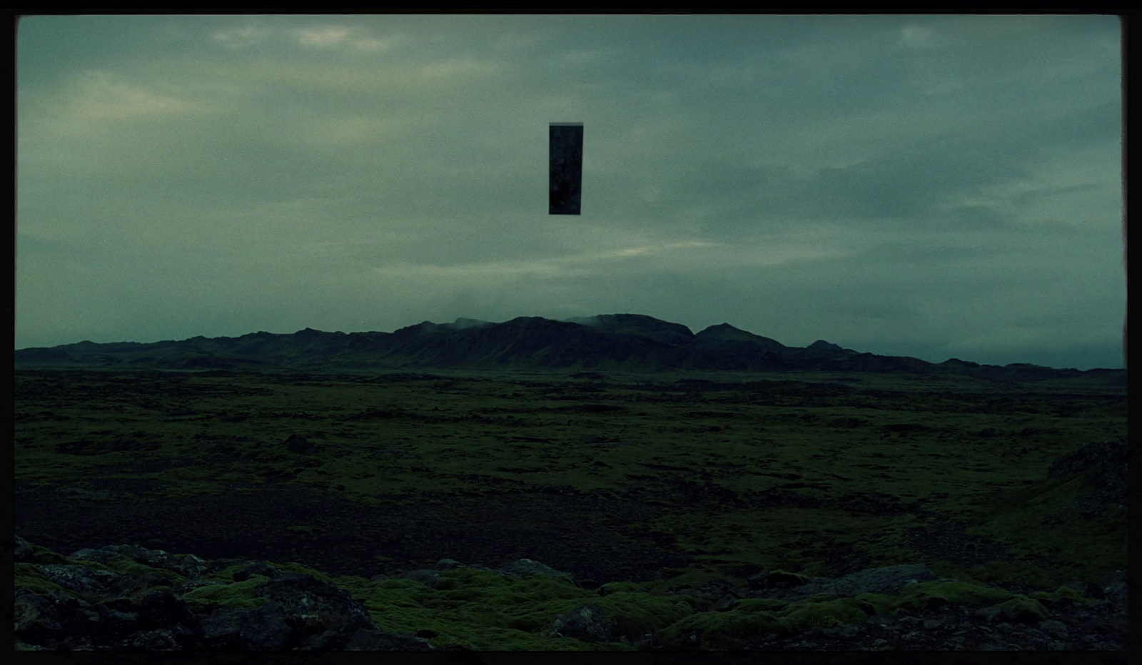 a kite flying in the sky over a field