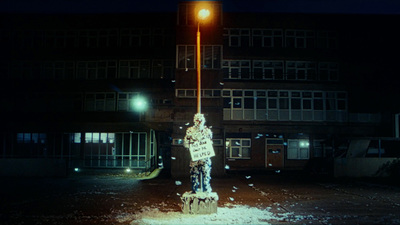 a fire hydrant in front of a building at night